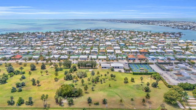 drone / aerial view featuring a water view and a residential view