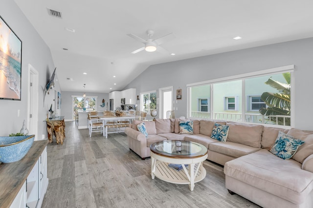 living area with ceiling fan, light wood-style flooring, vaulted ceiling, visible vents, and recessed lighting