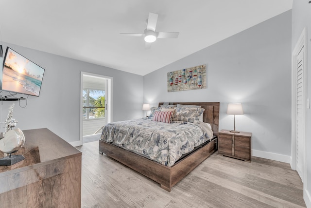 bedroom featuring a ceiling fan, baseboards, light wood finished floors, and lofted ceiling
