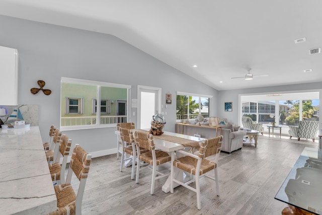 dining space with light wood-style flooring, a ceiling fan, lofted ceiling, and recessed lighting