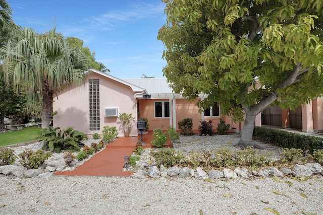 view of front of property with a wall mounted AC