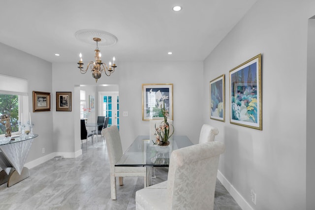 dining room with french doors and a chandelier