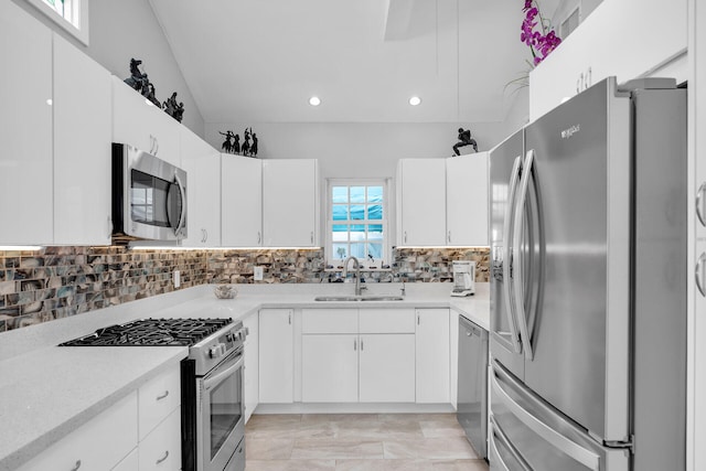 kitchen featuring stainless steel appliances, tasteful backsplash, sink, and white cabinets