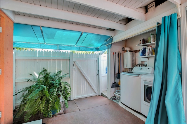 laundry area featuring tankless water heater and separate washer and dryer