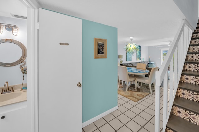 40 High Point Rd Unit C105, Tavernier, FL 33070 - hallway with a sink, stairway, light tile patterned floors, and baseboards