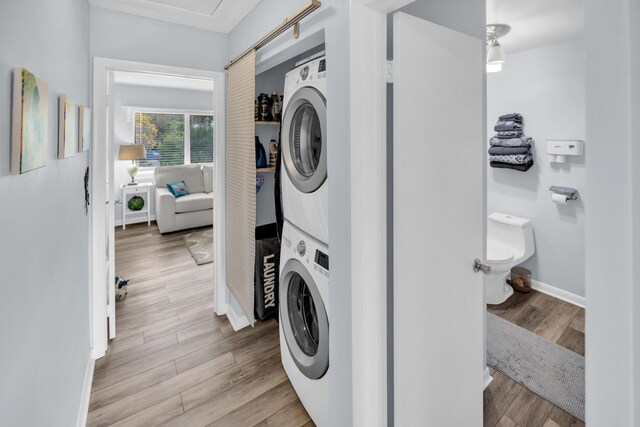 40 High Point Rd Unit C105, Tavernier, FL 33070 - laundry room with stacked washer / drying machine, wood finished floors, and baseboards