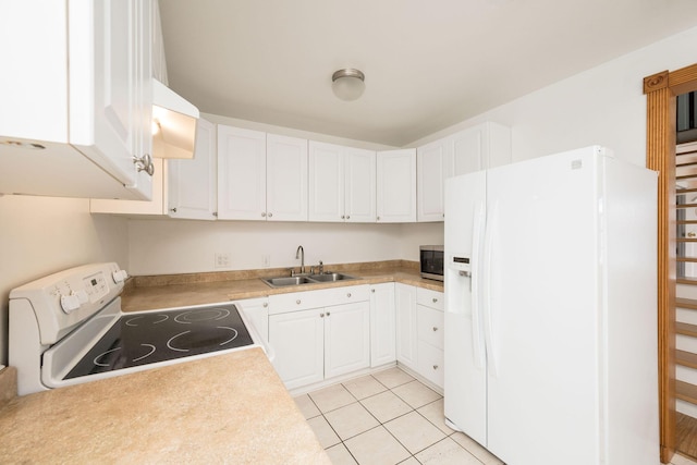 kitchen featuring a sink, white cabinets, and white appliances
