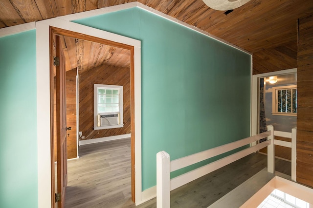 bonus room featuring wood walls, wooden ceiling, wood finished floors, and lofted ceiling