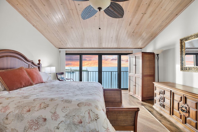 bedroom with lofted ceiling, wood ceiling, hardwood / wood-style flooring, ceiling fan, and access to exterior