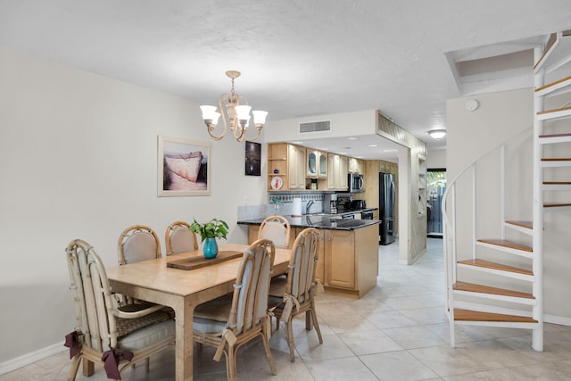 dining area with baseboards, visible vents, stairway, a notable chandelier, and light tile patterned flooring