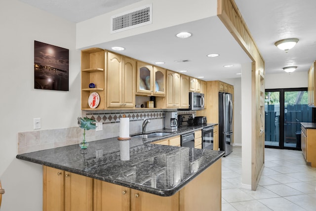 kitchen with sink, black appliances, kitchen peninsula, and dark stone counters