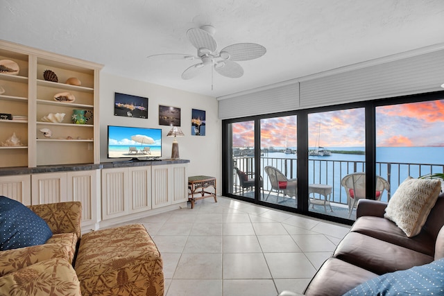 living room featuring a ceiling fan and light tile patterned floors