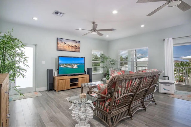 living room featuring plenty of natural light, light hardwood / wood-style floors, and ceiling fan