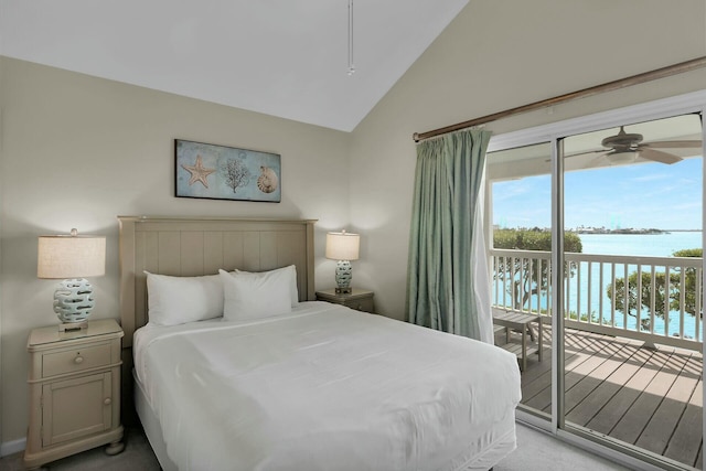 bedroom featuring a water view, access to exterior, and vaulted ceiling