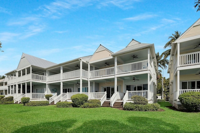 rear view of property with ceiling fan, a porch, and a yard