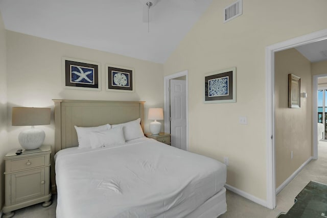 bedroom with light carpet, vaulted ceiling, visible vents, and baseboards