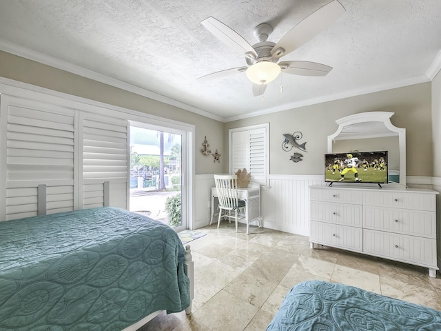 bedroom with ceiling fan, ornamental molding, and a textured ceiling