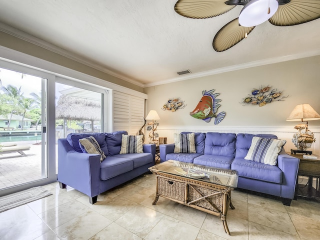 living room featuring crown molding, ceiling fan, and a textured ceiling