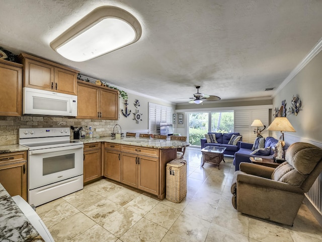 kitchen with decorative backsplash, ornamental molding, white appliances, kitchen peninsula, and a textured ceiling