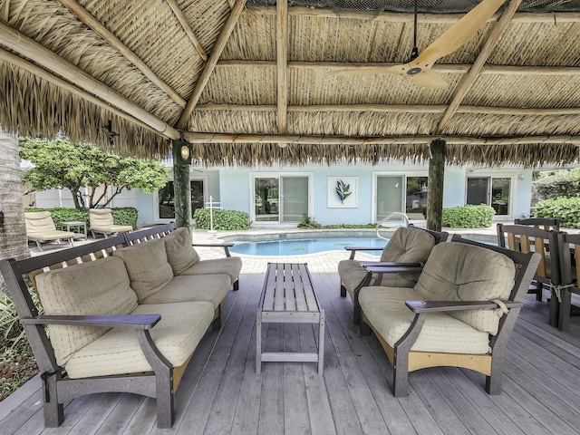 wooden terrace with an outdoor living space and a gazebo