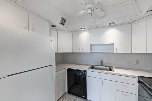 2000 Coco Plum Dr Unit 106, Marathon, FL 33050 - kitchen featuring black appliances, light countertops, and white cabinets
