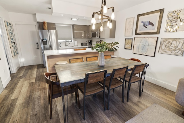 dining area featuring visible vents, baseboards, and dark wood-style flooring