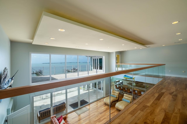 hallway featuring a water view and hardwood / wood-style floors