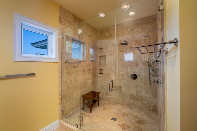 bathroom featuring a shower with shower door