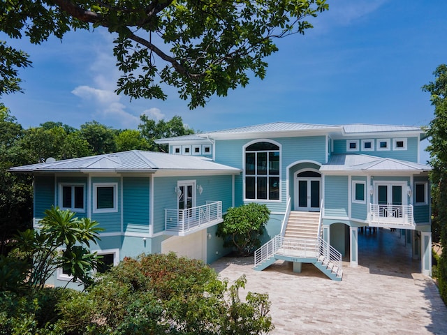 view of front of home featuring french doors and a carport