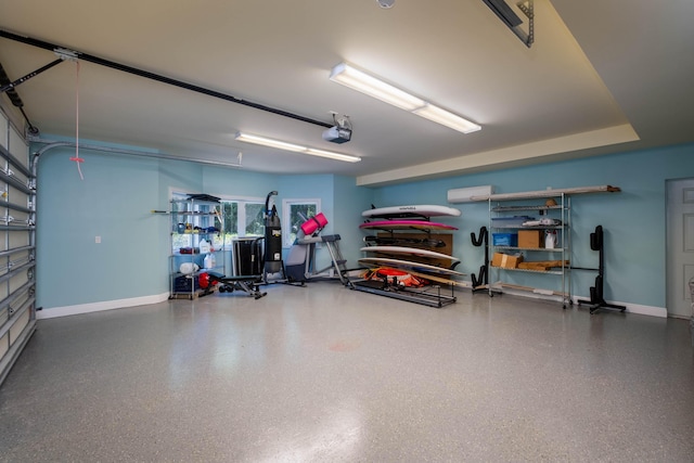 garage with a garage door opener and a wall unit AC