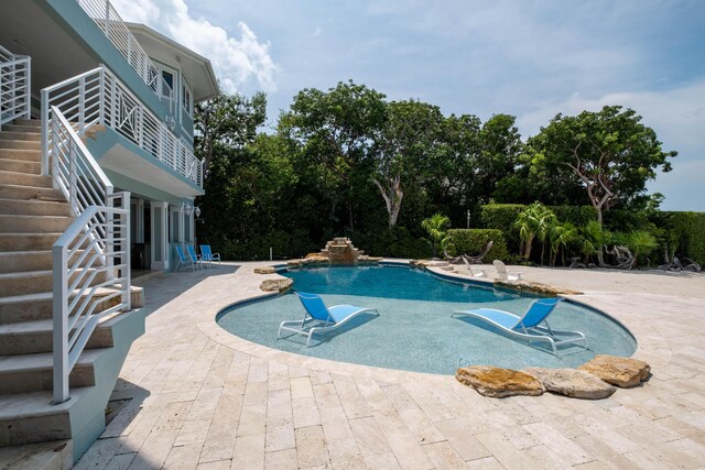 view of swimming pool with a patio area