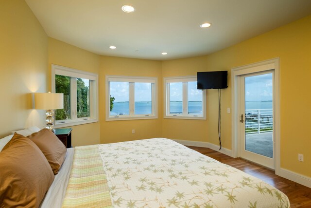 bedroom featuring wood-type flooring and access to outside