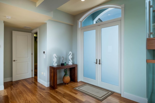 foyer entrance featuring hardwood / wood-style flooring and french doors