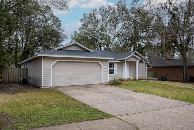 ranch-style home featuring central air condition unit, a garage, fence, driveway, and a front yard