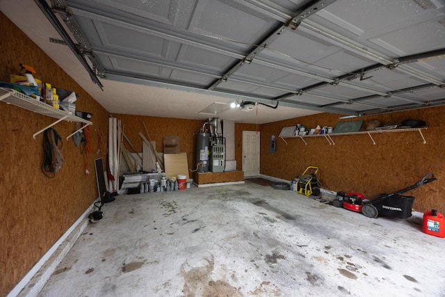 garage with a garage door opener and electric water heater