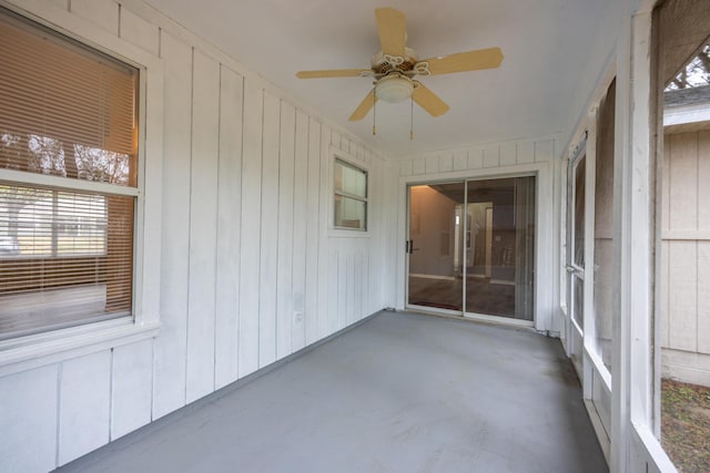 unfurnished sunroom with ceiling fan