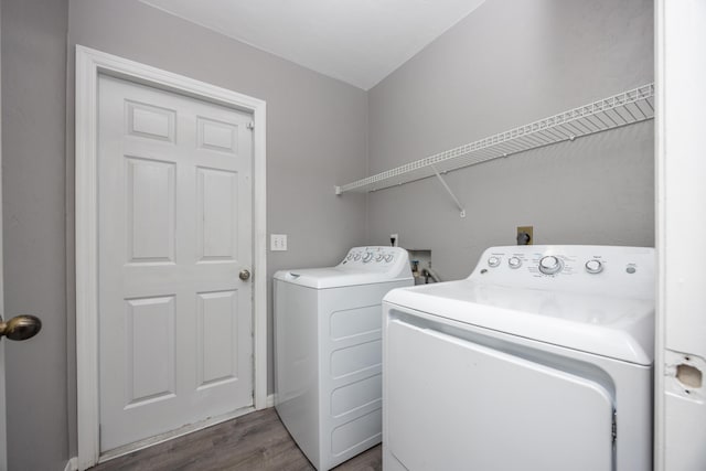 laundry room with wood finished floors, laundry area, and separate washer and dryer