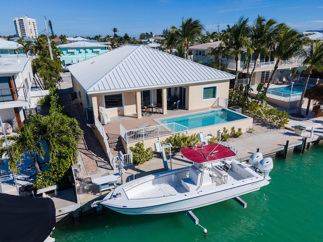 rear view of house featuring a water view and a patio