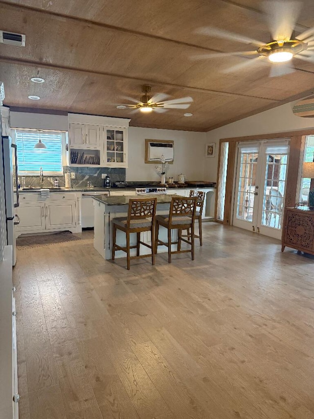 1672 Pandorea Ln, Big Pine, FL 33043 - kitchen with ceiling fan, dark countertops, dishwasher, white cabinetry, and light wood-style flooring