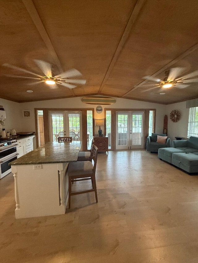 1672 Pandorea Ln, Big Pine, FL 33043 - kitchen with ceiling fan, plenty of natural light, dark countertops, white cabinets, and wood ceiling