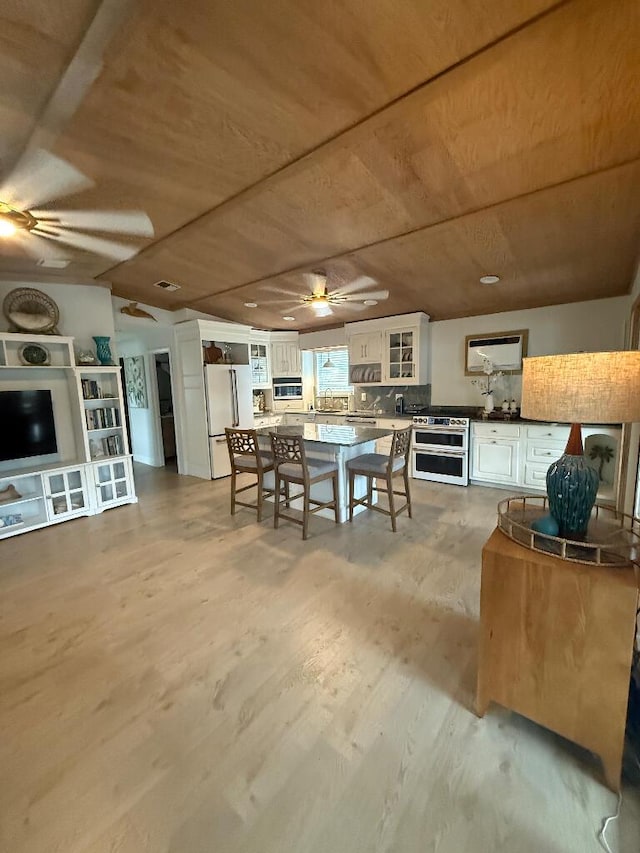 1672 Pandorea Ln, Big Pine, FL 33043 - dining room featuring ceiling fan, wood ceiling, and light wood finished floors