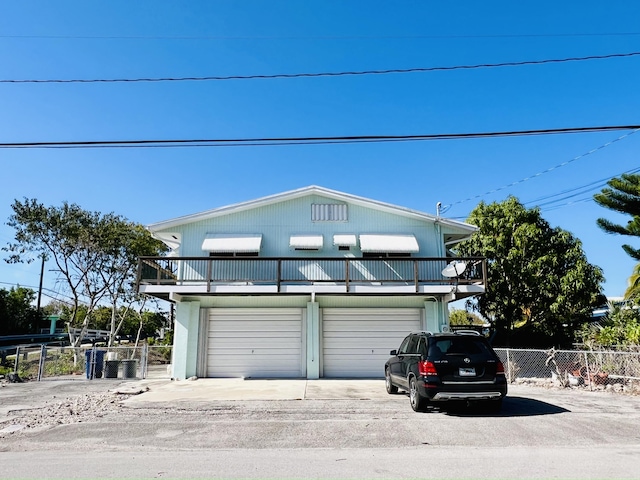 view of front of house with a balcony and a garage