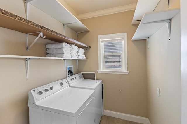 clothes washing area featuring ornamental molding and washing machine and clothes dryer