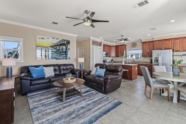 living room featuring ceiling fan, ornamental molding, and light tile patterned floors