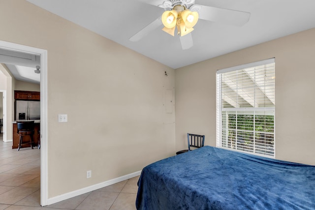 bedroom featuring ceiling fan, stainless steel fridge, and light tile patterned floors