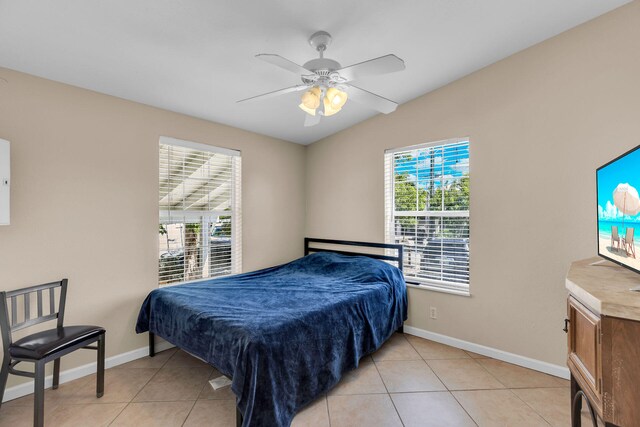 tiled bedroom with lofted ceiling and ceiling fan