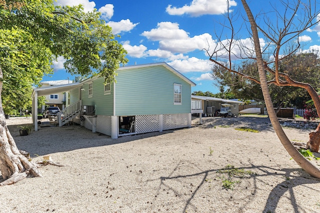 view of side of property with a carport and cooling unit