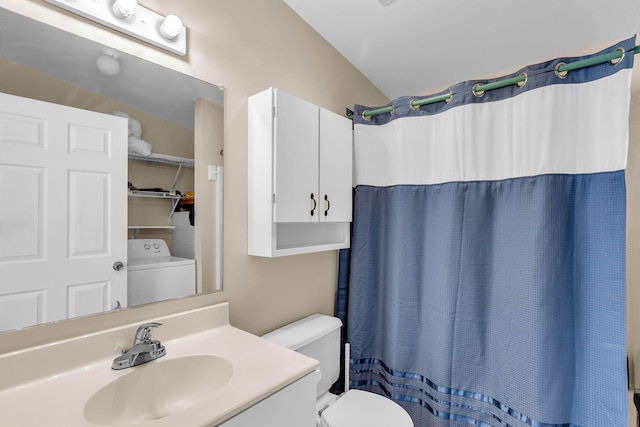 bathroom with walk in shower, toilet, washer / dryer, vaulted ceiling, and vanity