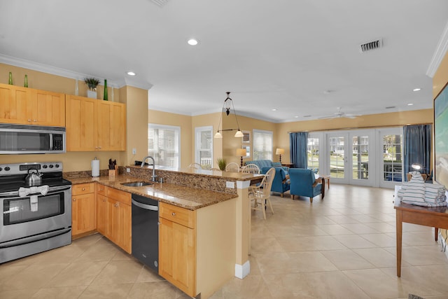 kitchen with french doors, stainless steel appliances, kitchen peninsula, and sink