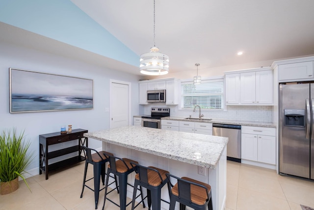 453 Lime Dr, Key Largo, FL 33037 - kitchen featuring appliances with stainless steel finishes, a sink, backsplash, a center island, and lofted ceiling